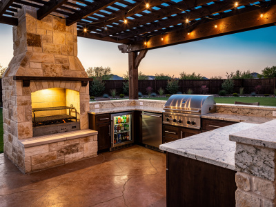Custom stone outdoor kitchen with built-in grill and counter space