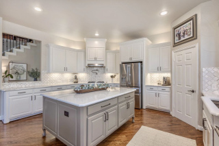 Custom kitchen remodel with shaker cabinets, quartz countertops, and tile backsplash